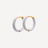 White hoop earrings with gold accents on a white background