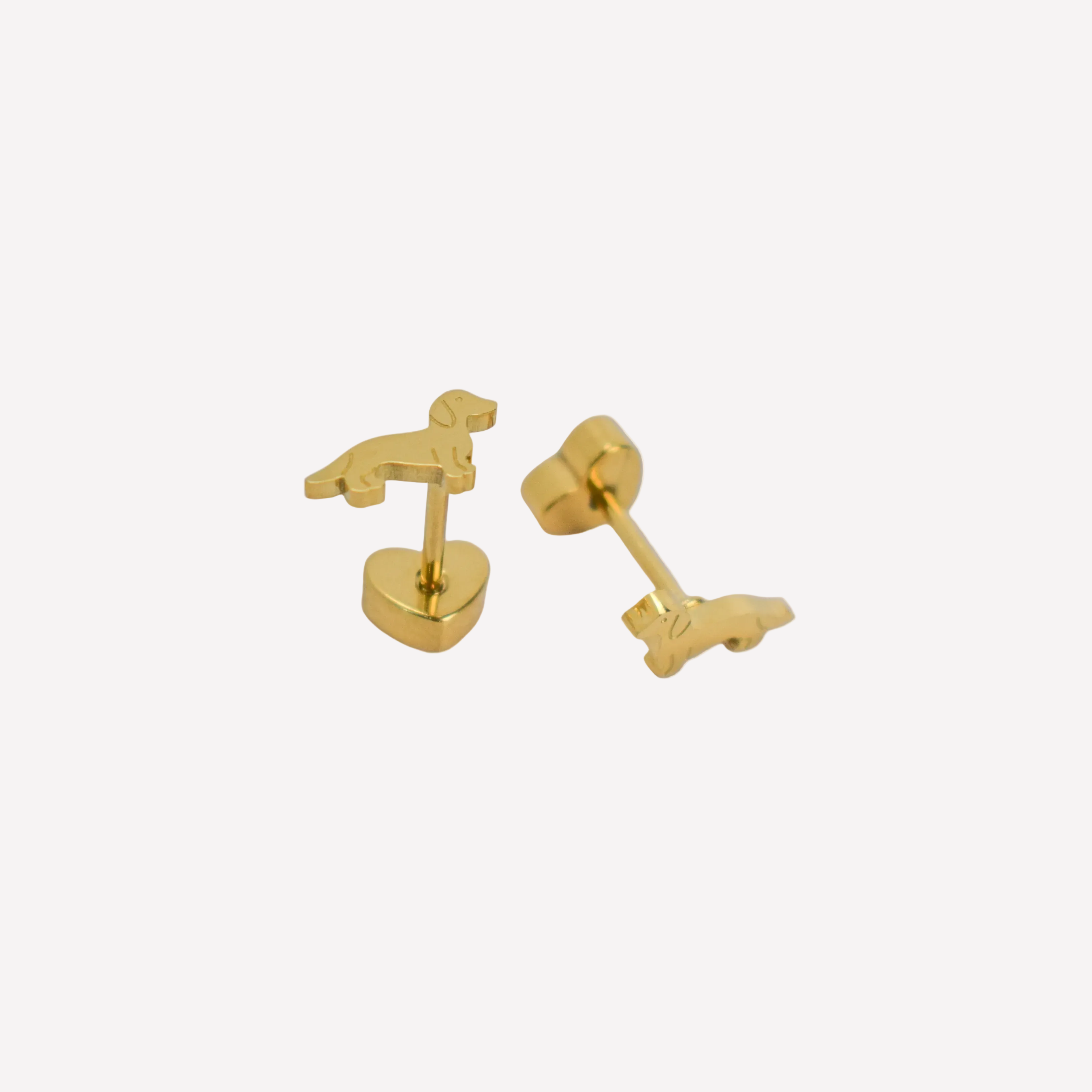 Gold dog-shaped earrings on a white background