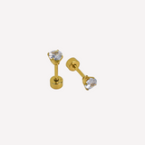Pair of gold stud earrings with clear gemstones on a white background