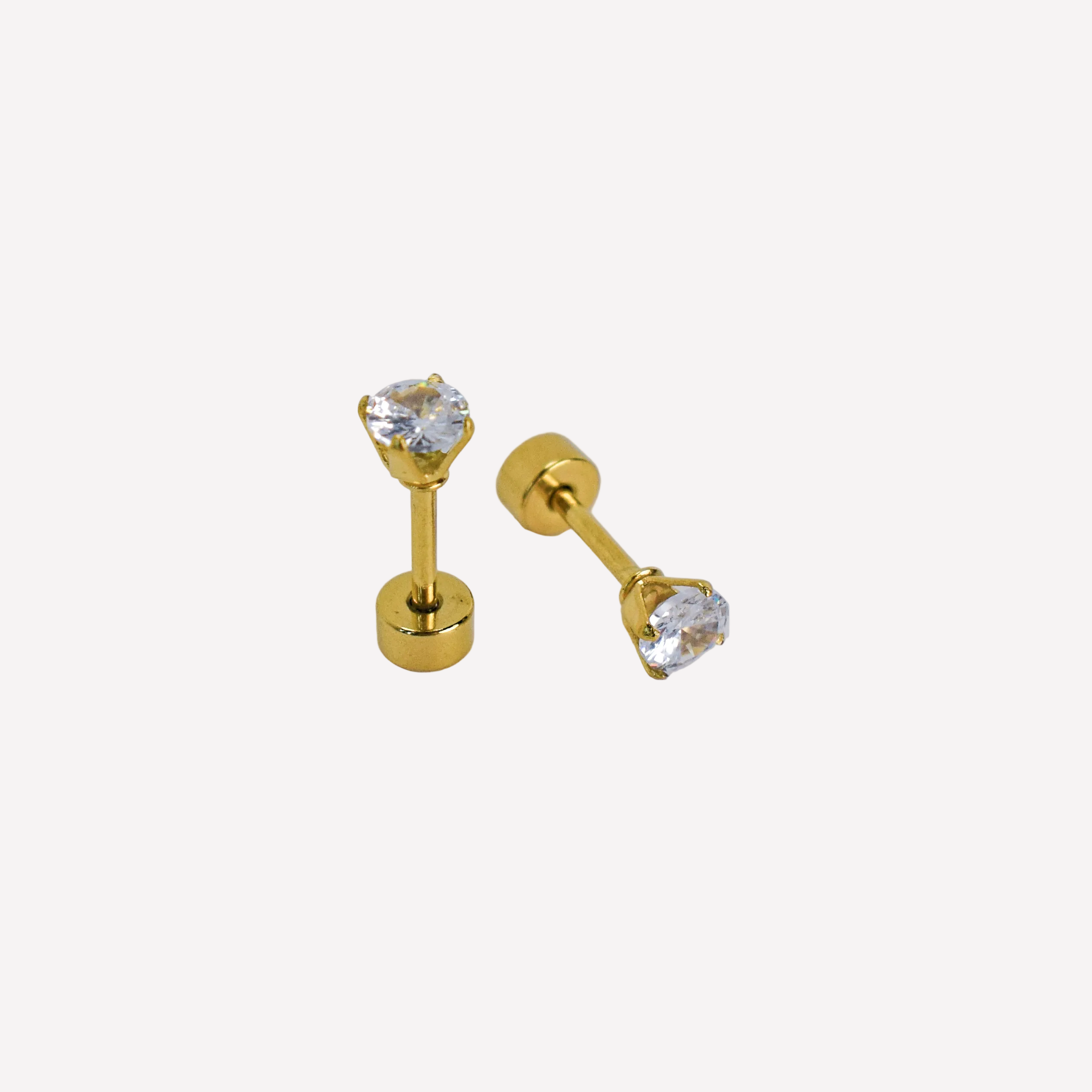 Pair of gold stud earrings with clear gemstones on a white background