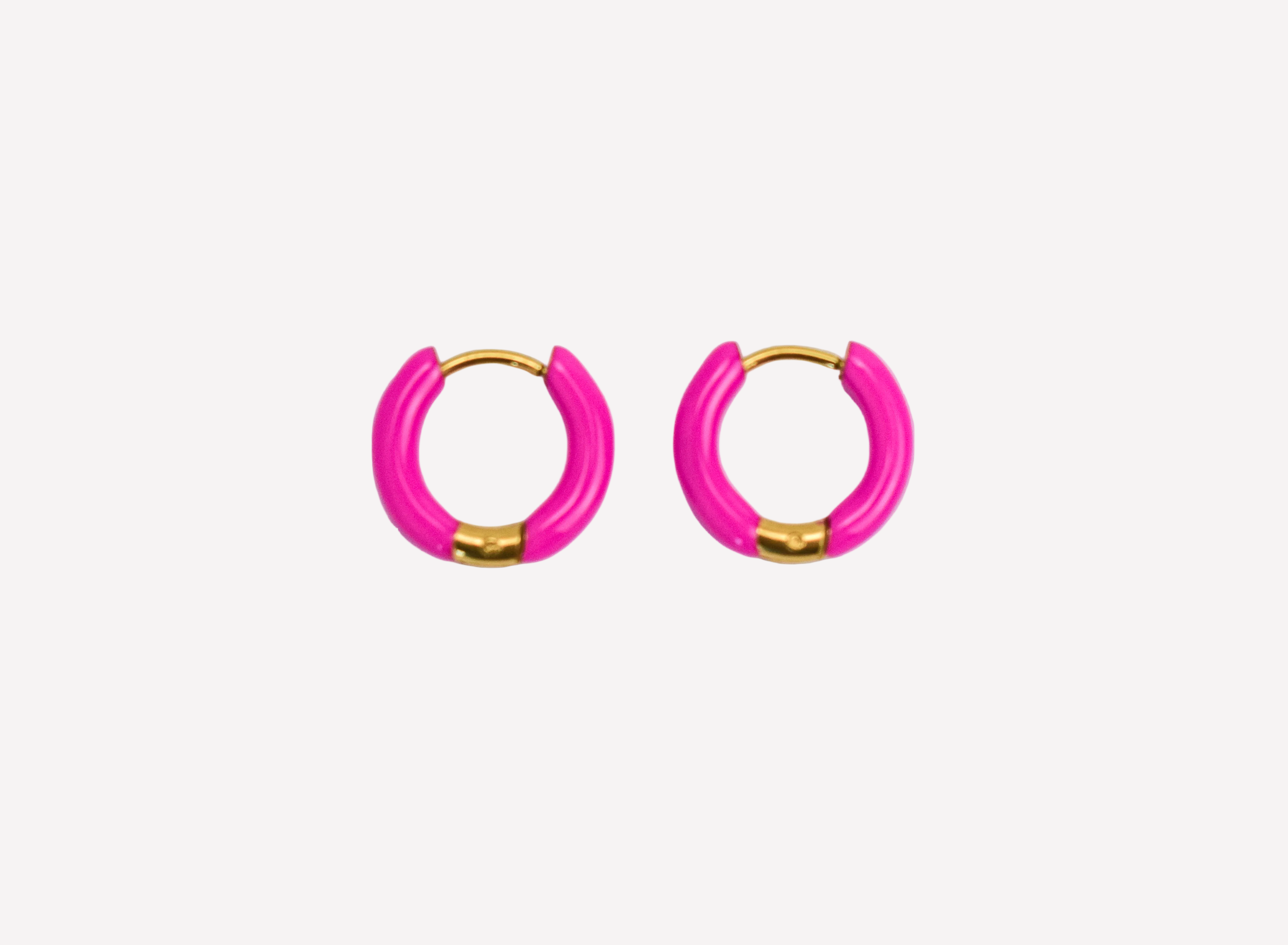 Pair of pink hoop earrings with gold accents on a white background
