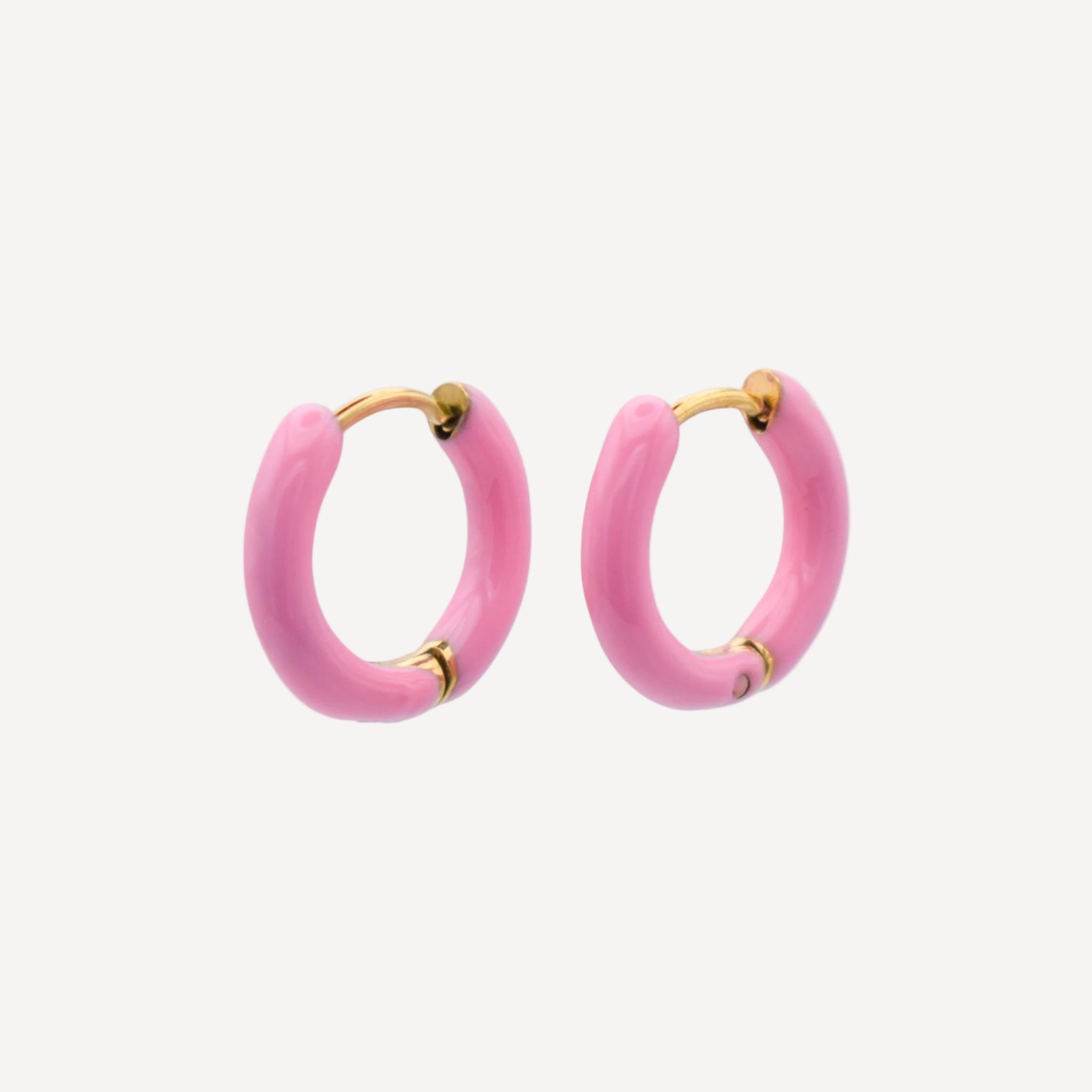 Pink hoop earrings with gold accents on a white background