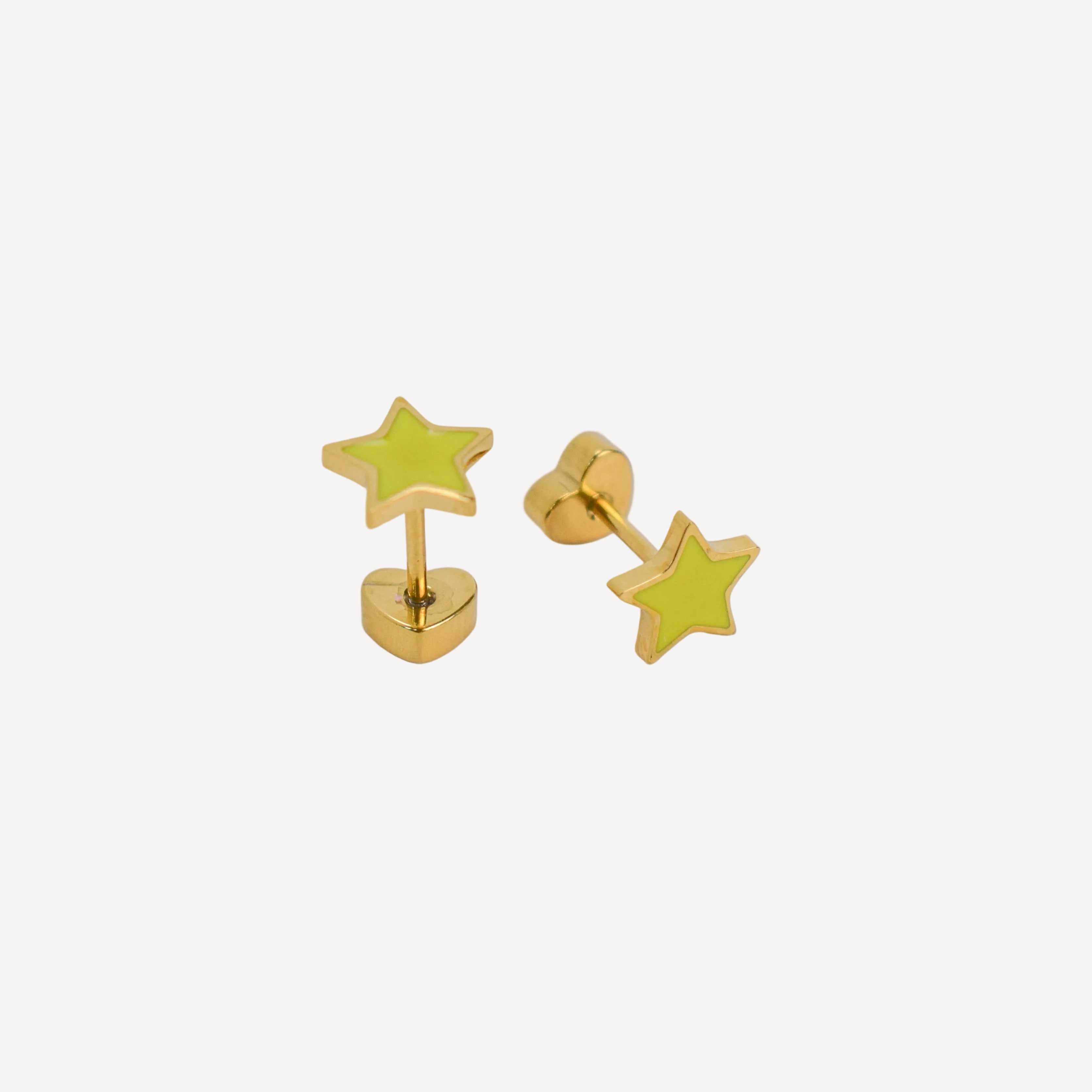 Gold star-shaped earrings on a light gray background