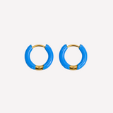 Pair of blue hoop earrings with gold accents on a white background