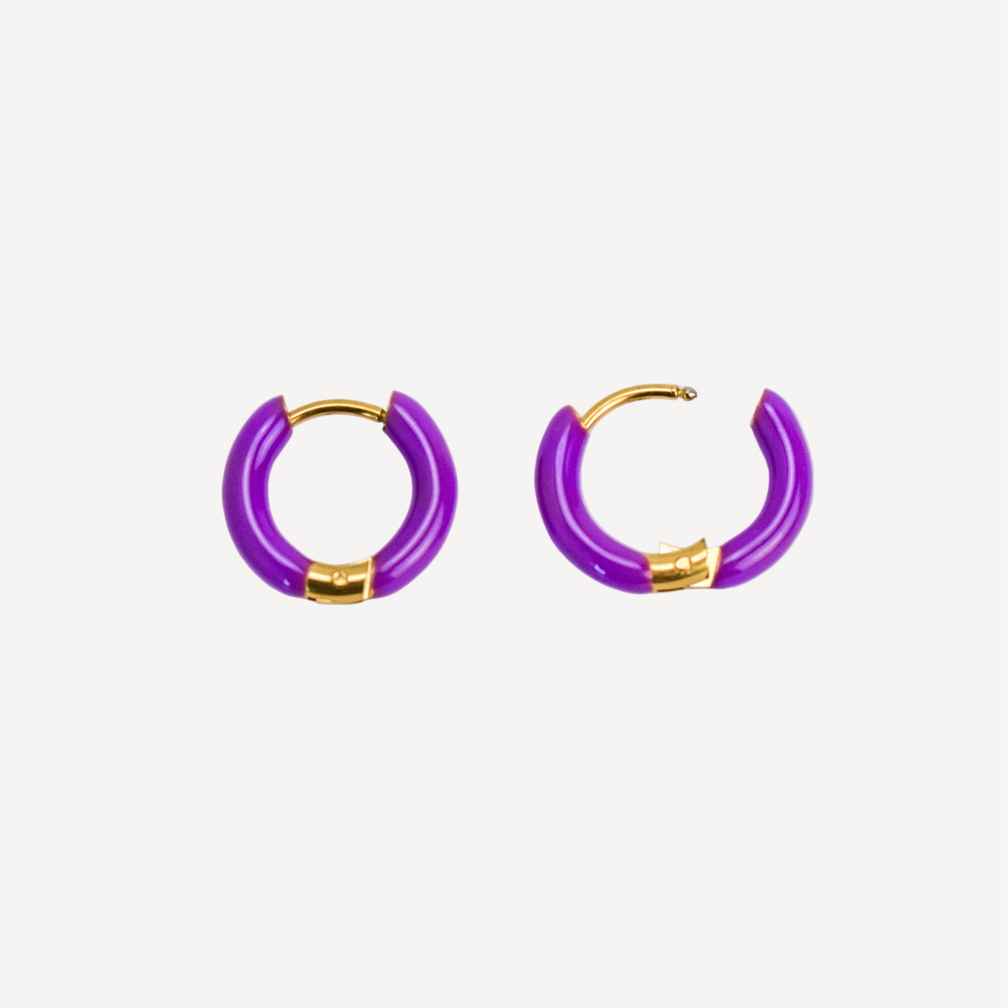 Purple hoop earrings with gold accents on a white background