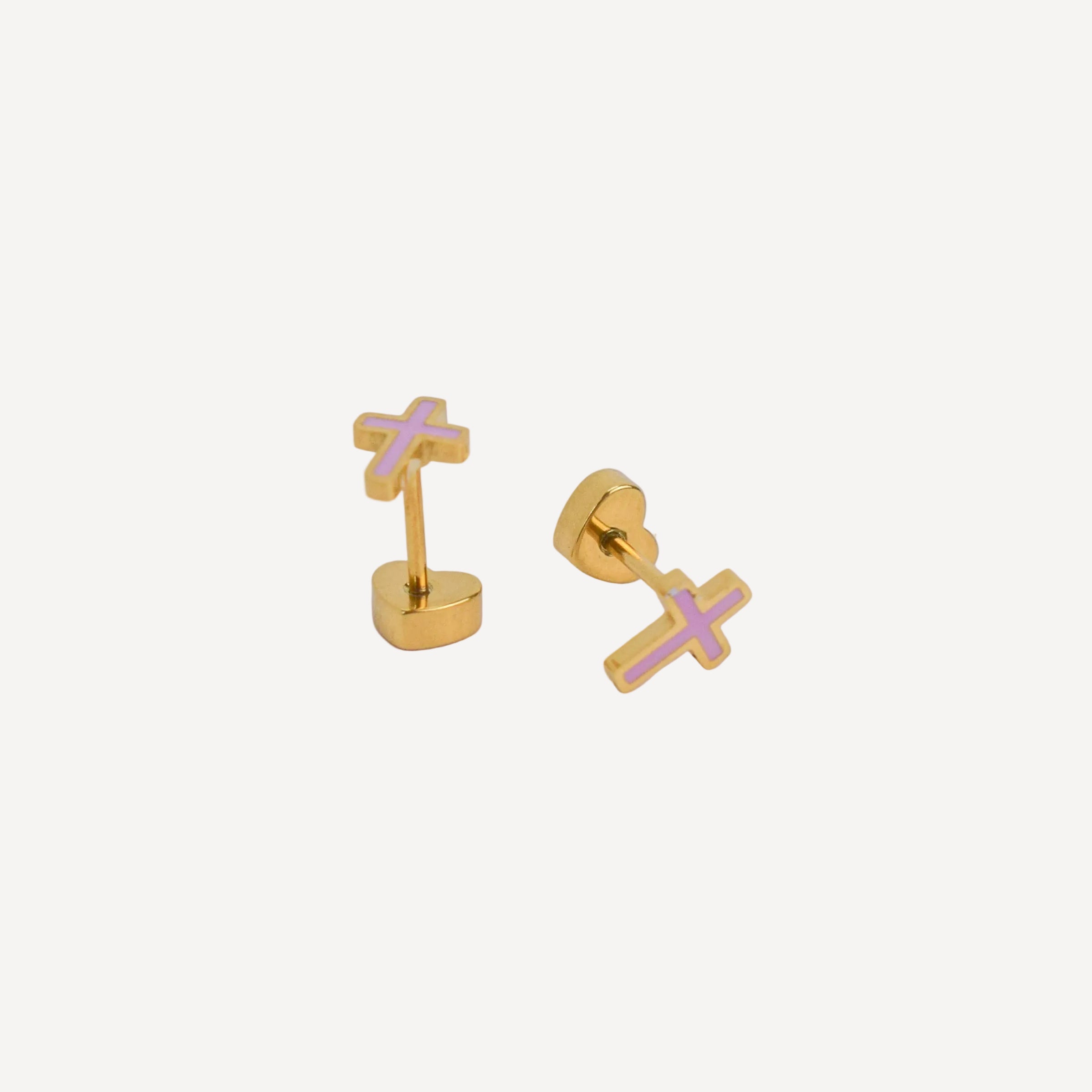 Gold cross-shaped earrings on a light gray background