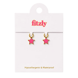 A pair of small pink star-shaped hoop earrings with gold-tone rims, displayed on a white Fitzly retail card against a white background.